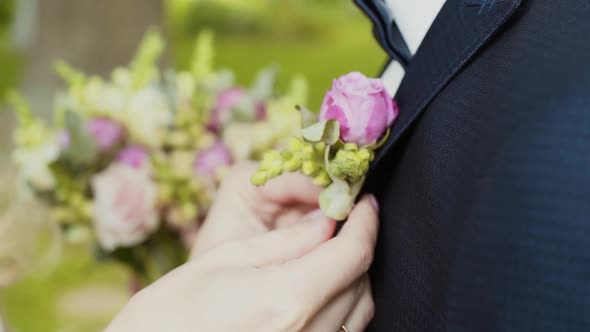 Bride Cling Buttonhole of Pink Roses on Lapel of Groom's Jacket with Pin