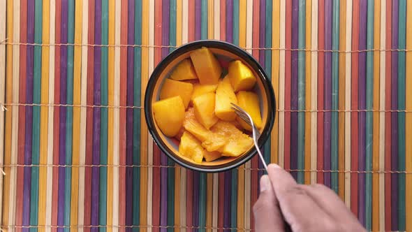  Man Eating Yellow Ripe Cut Mango Top Down 