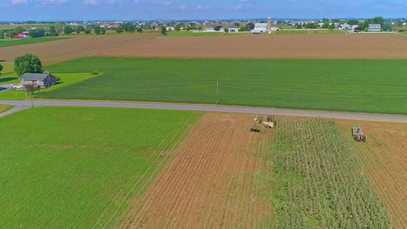 Aerial View of Rural America of Amish Farmlands With Amish Harvesting the Crops