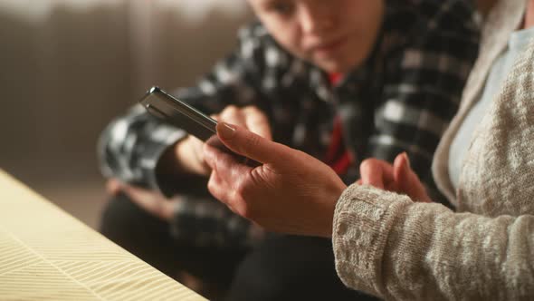 Grandson Helping Grandma with Smartphone