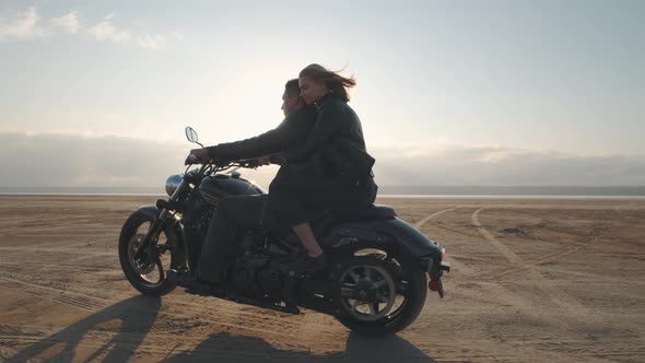 Guy with a Girl on a Motorcycle in the Desert