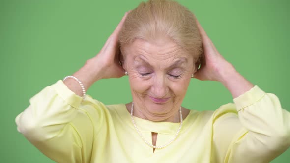 Beautiful Senior Businesswoman Covering Ears As Three Wise Monkeys Concept