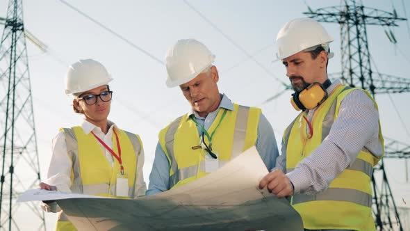 Energetics Workers Are Talking While Observing Layouts