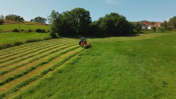 Silage Harvester Driven On Vast Green Field In Hjelmeland Norway - aerial shot