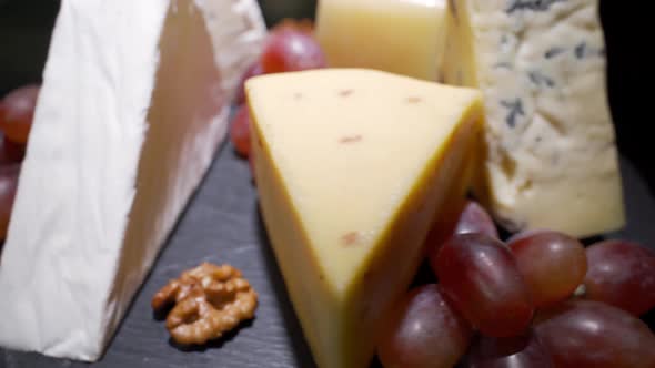 Cheese Plate Close-up with Several Varieties of Fruit and Honey Cheese