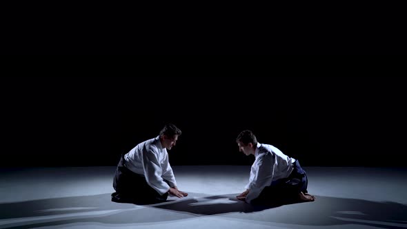 Two Masters Martial Arts Aikido Bow To Each Other. Shot Isolated on Black and White Background