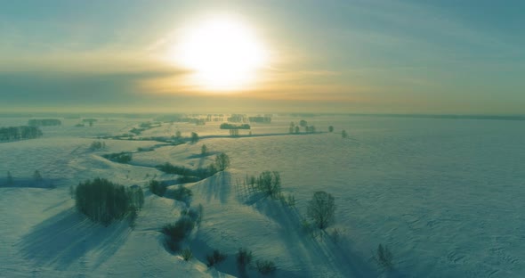 Aerial View of Cold Winter Landscape Arctic Field Trees Covered with Frost Snow Ice River and Sun