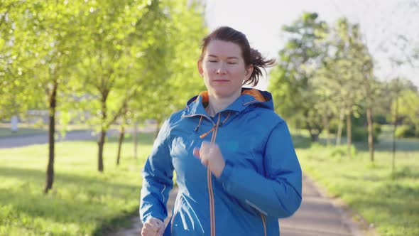 Slow Motion Woman Jogging in Green Park