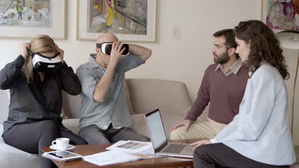 Two Architects Talking with Clients in Office