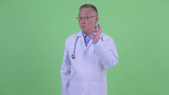 Happy Mature Japanese Man Doctor with Ok Sign