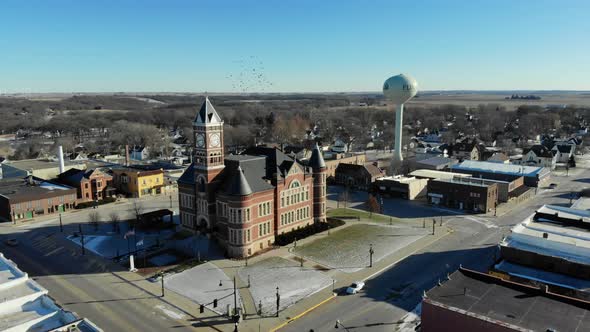 Drone video circling around a historic brick Court house building in a small town in rural America