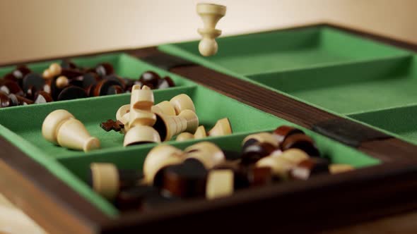 Falling Old Wooden Chess Pieces Into the Box