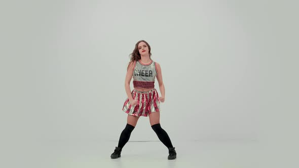 Solo Performance of an Attractive Cheerleader in the Studio on a White Background
