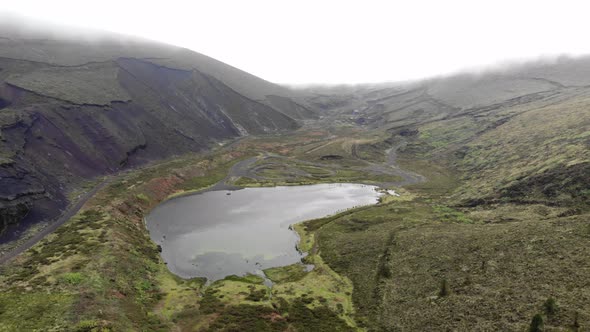 Lagoa do Peixe, one of the smallest lagoons in São Miguel Island, Azores - Aerial pull out fly-over
