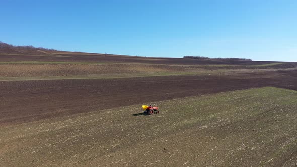 Flying Over a Tractor Planting Seeds