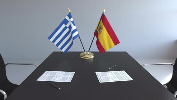 Flags of Greece and Spain on the Table
