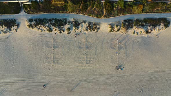 Top View Of People On White Sand Beach At Summer. aerial top-down