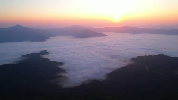 4K Aerial video Beautiful sunrise above dense clouds and fog in the morning