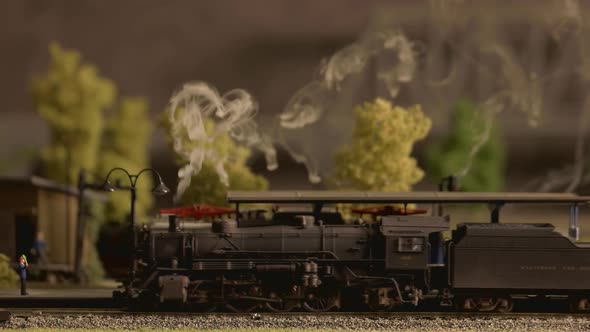 Model Steam Train Moving Through Station Close Up.