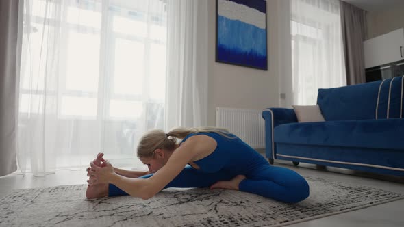 A Beautiful Young Woman Performs Exercises Without Leaving Home