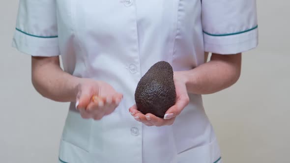 Nutritionist Doctor Healthy Lifestyle Concept - Holding Organic Avocado