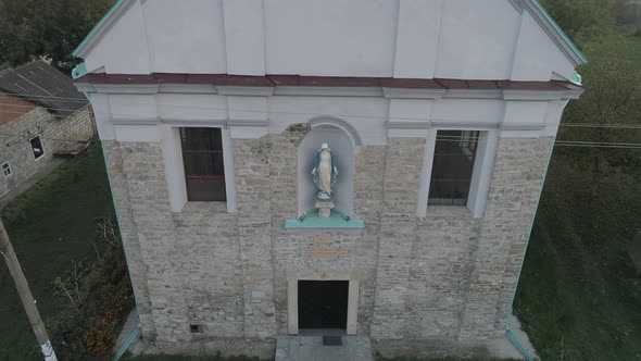 Aerial of a church with a sculpture