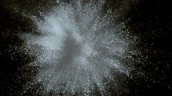 White powder exploding on black background in super slow motion, shot with Phantom Flex 4K alt