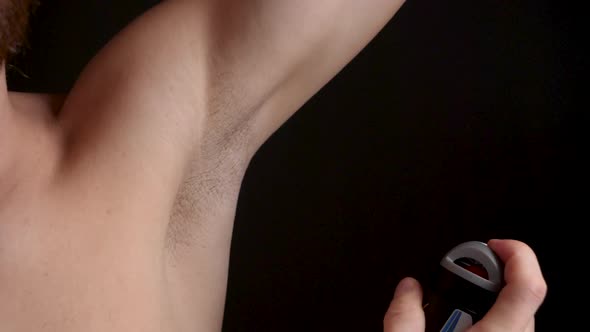 Man Using Deodorant Spray on His Armpit to Prevent Perspiration, Close-up