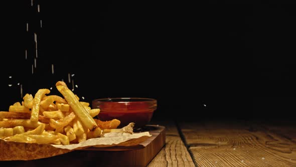 Adding Salt on French Fries. Slow Motion.