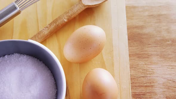 Various ingredients and brown egg on wooden table