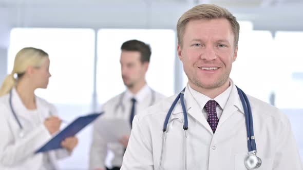 Portrait of Cheerful Male Doctor Smiling at the Camera