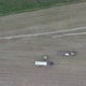 Aerial of Tractor Baler Making Straw Bales in Field After Wheat Harvest in Summer on Farm - VideoHive Item for Sale