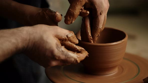 Woman Using Potters Wheel in Pottery