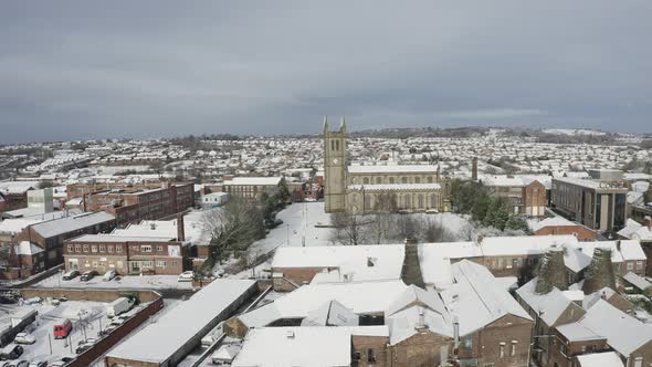 Aerial view of St Jame's church covered in snow in the midlands, Christian, Roman catholic religious