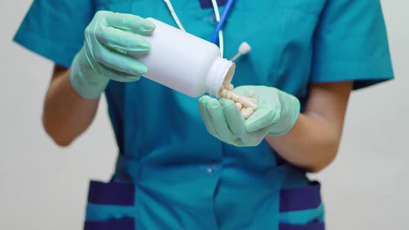 Medical Doctor Nurse Woman Wearing Protective Mask - Holding Can of Pills or Vitamins