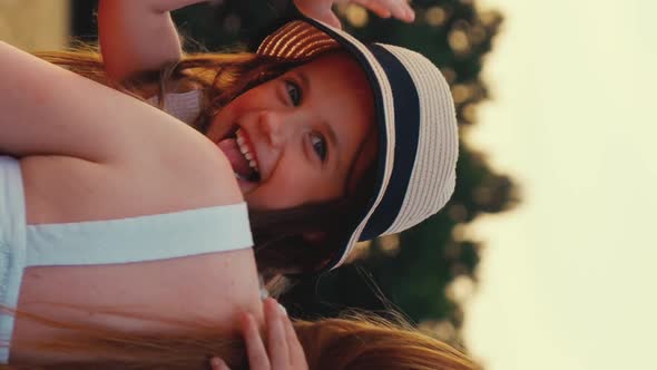 Vertical Screen Mom Running in Field with Happy Daughter in Arms