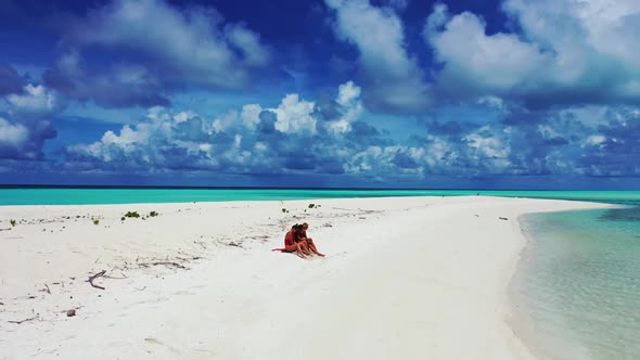 Girls enjoying life on paradise coastline beach trip by blue lagoon with white sand background of th