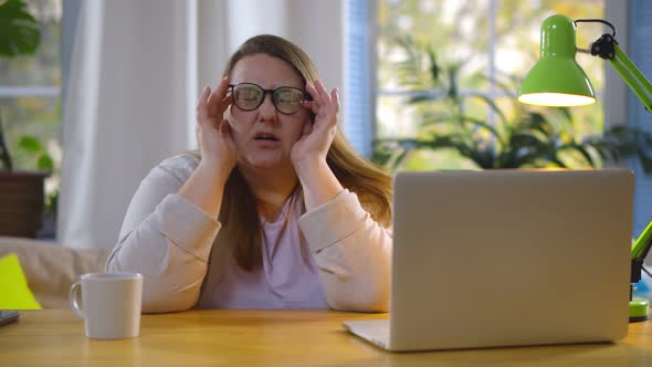 Tired Fat Woman Suffering Eyestrain Working on Laptop at Home