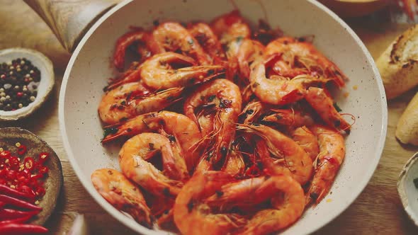 Traditional Fried Tiger Prawn with Garlic Bread As Top View Served in a White Frying Pan