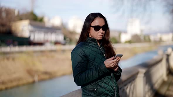 Pretty Female Dweller of Small Provincial City is Enjoying Good Spring Weather in Sunny Day in Town