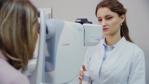 The Ophthalmologist Examines the Patient's Eye and Then Looks Into the Camera