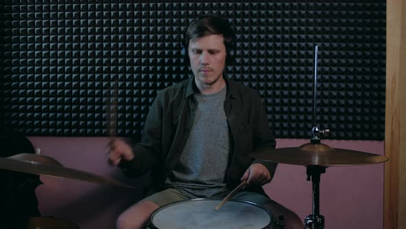 Man Sits Down to Play the Drum Set