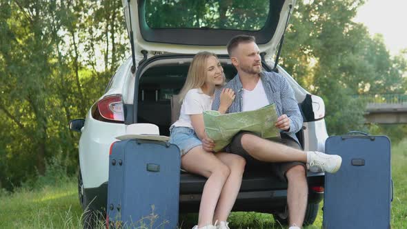 Happy Couple Traveling By Car