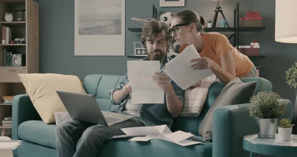 Couple checking bills and paperwork at home