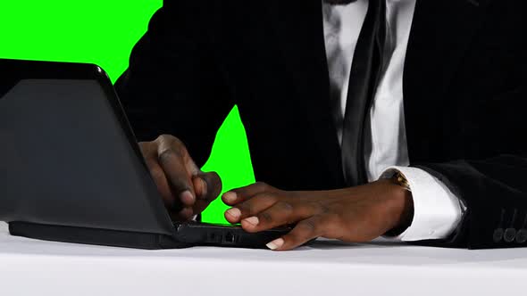 Young Businessman Working on His Laptop at His Desk. Green Screen