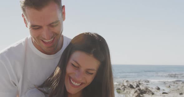 Young adult couple relaxing by the sea