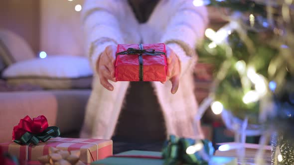 close-up asian female hand present sending present gift box