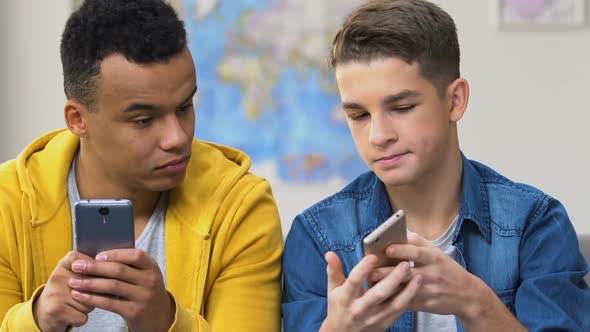 Two High Schoolers Browsing Dating Apps on Smartphones, Choosing Girlfriends