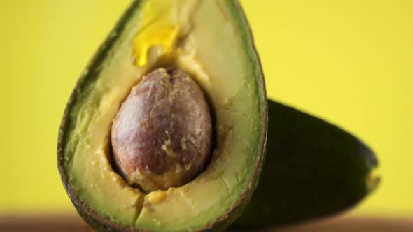 Pouring Oil Over Cut Avocado. Slow Motion.