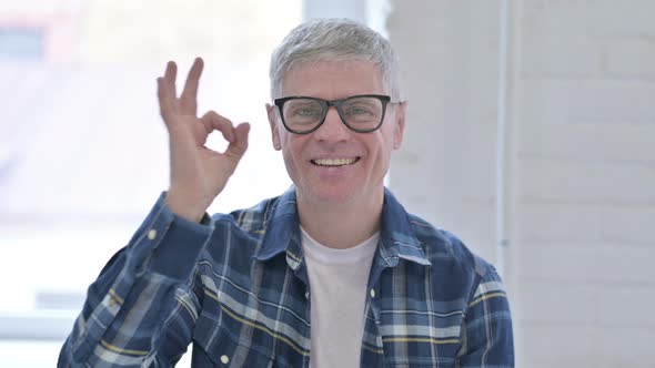 Portrait of Cheerful Casual Middle Aged Man Doing OK Sign